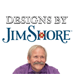 Older man with a mustache and a purple shirt smiles below the text Designs by Jim Shore in bold blue and black letters with a decorative star in the letter O.