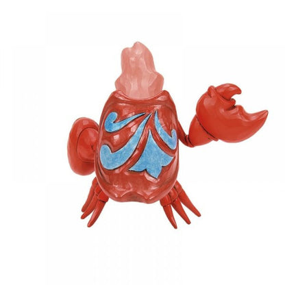 The Disney Traditions Sebastian Mini Figurine by Jim Shore (6015021) features a red crab with a pink crystal-like back, blue shell patterns, and one raised claw—ideal for fans of this charming collectible.