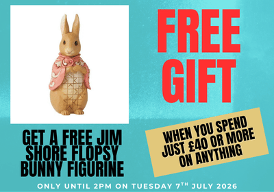 Promotional banner featuring a Jim Shore Flopsy Bunny figurine in the center, with large red text reading 'FREE GIFT' on the left and black promotional text on the right over a turquoise background.