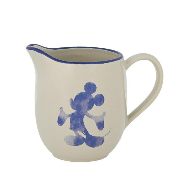 The Disney Home Mono Cream Jug (A30830) is cream-colored with a blue rim and handle, featuring a blue watercolor-style Mickey Mouse silhouette on the side.