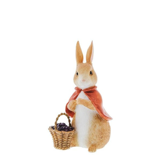 The Beatrix Potter Flopsy Bunny With Berries Figurine features a light brown rabbit in a red cape, standing upright with a basket of dark purple berries and a white belly.
