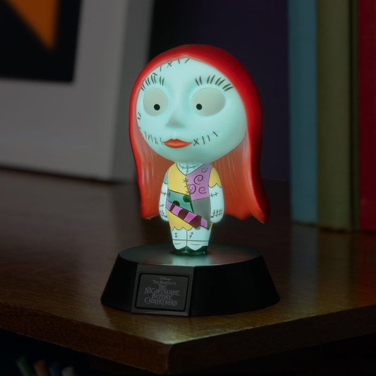 The Disney NBC Sally Icon Light by Paladone features Sally from The Nightmare Before Christmas, softly glowing with her red hair and patchwork dress atop a black base—a delightful display for any tabletop.