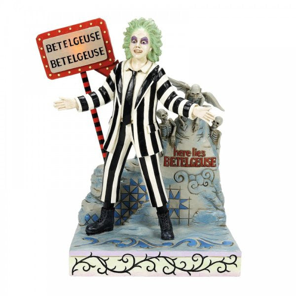 The Beetlejuice By Jim Shore LED Light-up Figurine (6016175) features Beetlejuice in his iconic striped suit by a gravestone, set on a swirling patterned base beneath a BETELGEUSE sign—capturing the quirky spirit of the film.