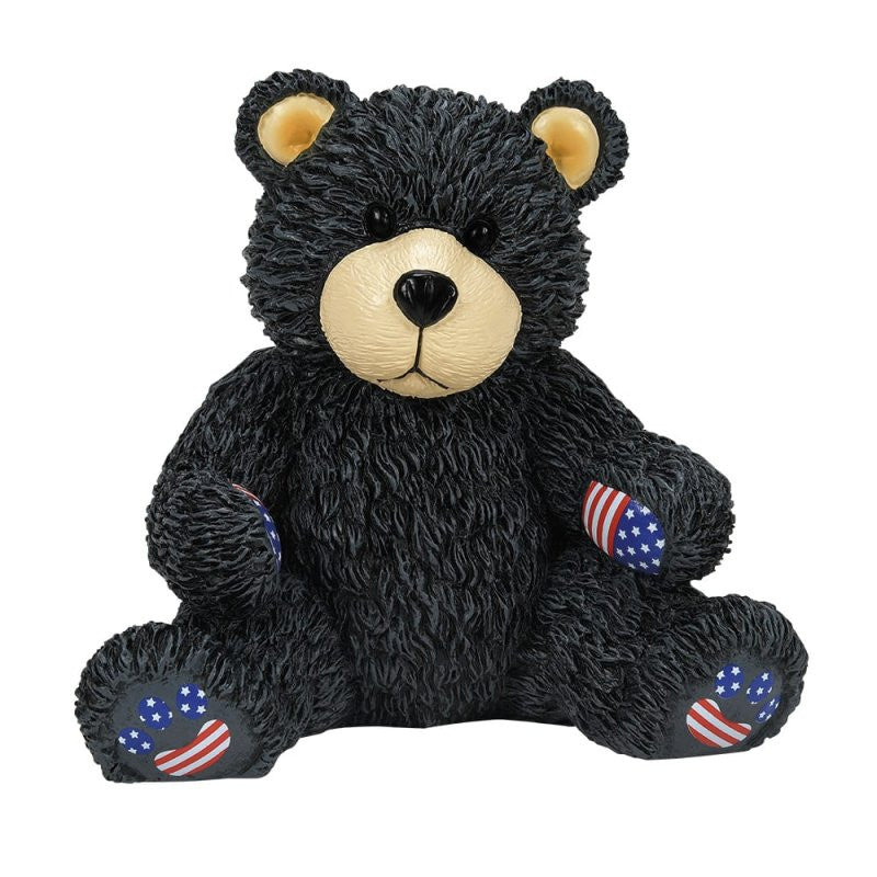 The Bubba Bearsevelt Figurine by Boyds Bears (6016928) features a black bear with a beige snout, yellow inner ears, and upright pose. Its paws display American flag stars and stripes, celebrating the brands 45th anniversary collection.