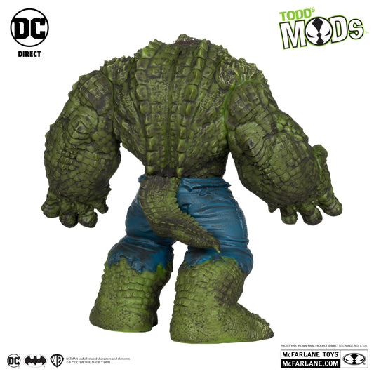 A headless, green, scaly Killer Croc with a lizard tail and torn blue pants is shown. Image features the McFarlane Toys DC Direct Killer Croc Todds Mods branding, plus DC and McFarlane Toys logos.