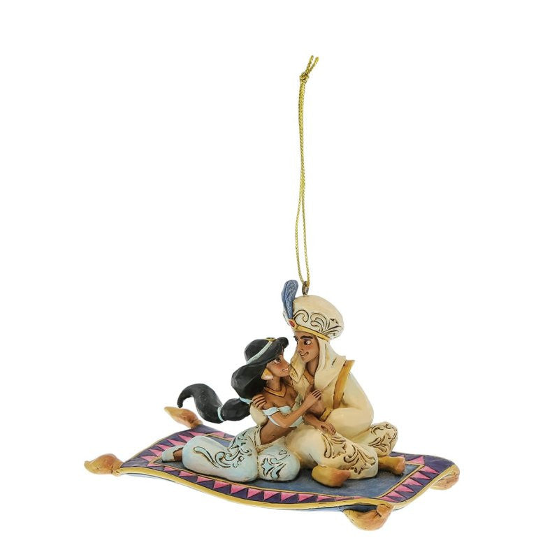 Disney Traditions Aladdin & Jasmine Hanging Ornament by Jim Shore 6017550 features the iconic duo on a flying carpet, detailed with a decorative border and gold string. From the Disney Traditions collection.