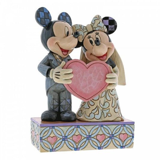 Disney Traditions Mickey as Groom & Minnie as Bride with a pink heart figurine
