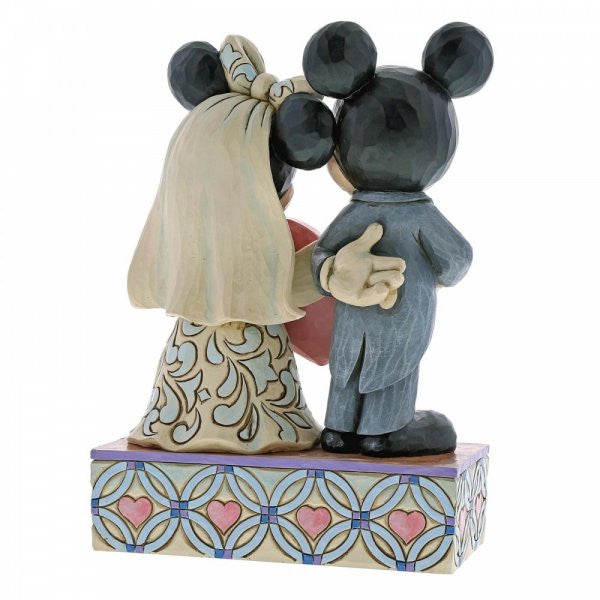 Disney Traditions Mickey as Groom & Minnie as Bride with a pink heart figurine