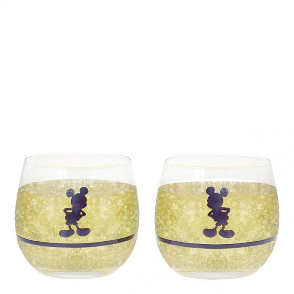 This set of 2 Disney Home Mono Mickey & Minnie Tumblers (A30845) features clear glass with a gold sparkling band and bold Mickey silhouettes, displayed empty and placed side by side.
