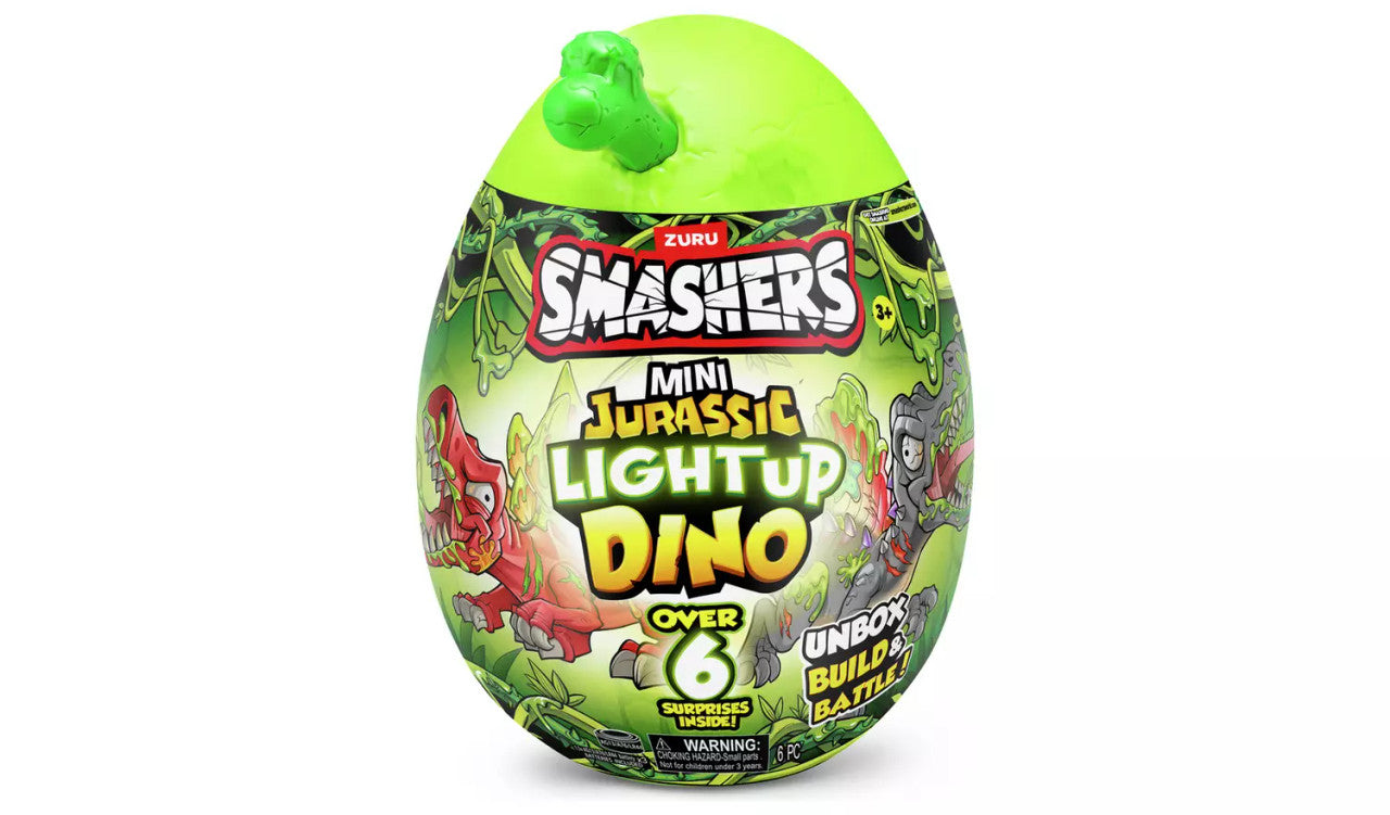 The Zuru Smashers Mini Jurassic Light-Up Dinosaur is a green, egg-shaped toy package with cartoon dinosaurs and Over 6 Surprises Inside text. The top features a small dinosaur head.