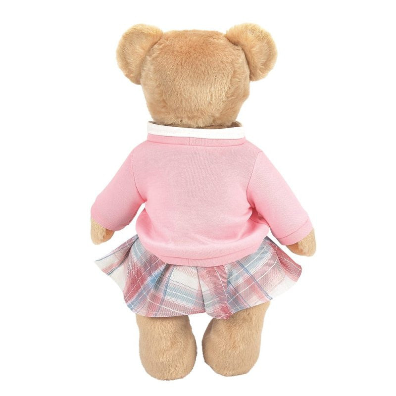 The Emma Boydsley Bear 14 Inch Plush Soft Toy by Boyds Bears (6017146) features light brown fur and wears a pink long-sleeve top with a pink, blue, and white plaid skirt for an adorable schoolgirl look.