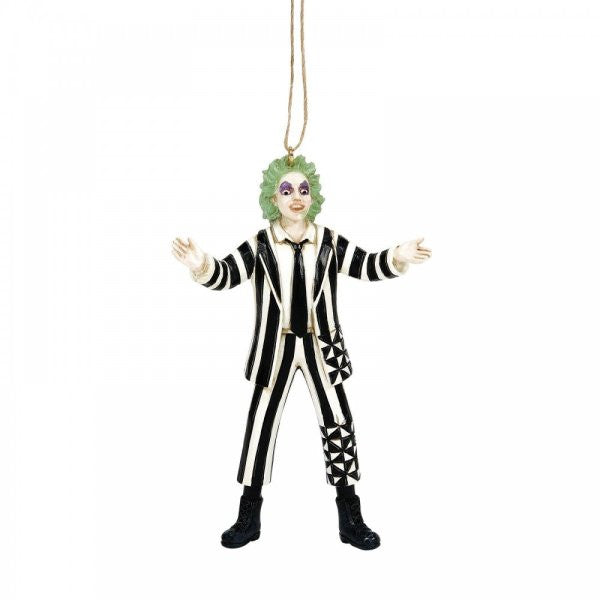 The Beetlejuice By Jim Shore Classic Beetlejuice Hanging Ornament 6016179 features the iconic character with green hair, pale face, dark eye makeup, black and white striped suit, black boots, and outstretched arms.