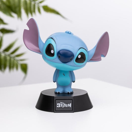 The Disney Stitch Icon Light by Paladone is a vinyl collectible featuring Stitch on a black base with the movie title—ideal for Disney fans. Large ears, big eyes, and green leaves stand out against a white background.