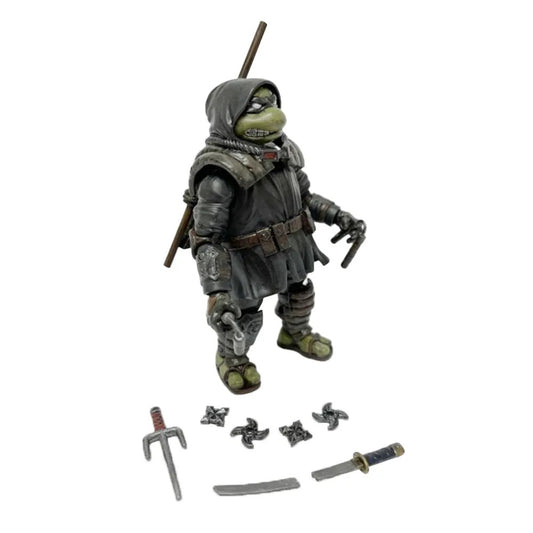 Bandai Namco’s Teenage Mutant Ninja Turtles The Last Ronin action figure features a dark hooded outfit, weapon in hand, and includes extra accessories—throwing stars, a sai, and swords—ideal for collectors.