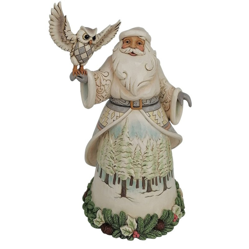 The Heartwood Creek By Jim Shore Santa’s Woodland Messenger (White Woodland Santa With Owl) Figurine 6017171 features a cream-robed Santa with an owl on his hand, and a base adorned with pine cones, holly leaves, and berries.