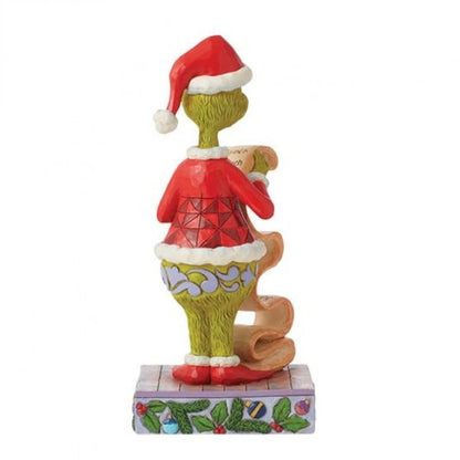 The Grinch Holding Naughty/Nice List Figurine By Jim Shore 6015217 by The Grinch By Jim Shore features the Grinch in a Santa hat and jacket on a decorated base, holding a scroll and showcasing detailed back view—ideal for Christmas celebrations.