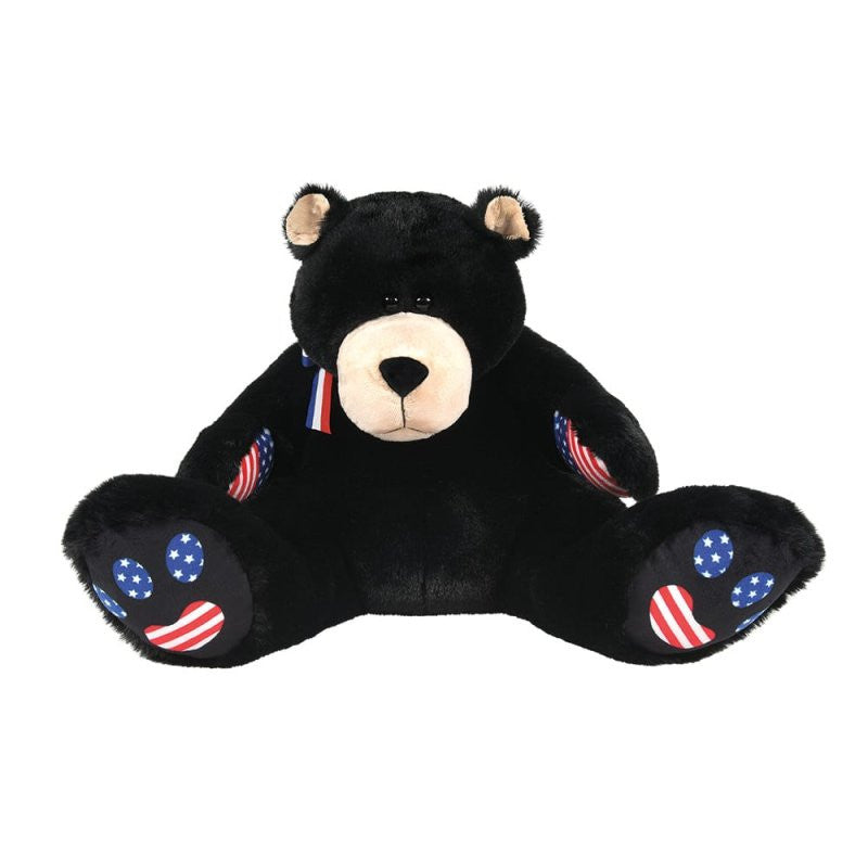 Meet Bubba Bearsevelt, a 16-inch plush soft toy by Boyds Bears, featuring a black coat, beige snout, American flag designs on its paw pads and ears, and a red, white, and blue ribbon.