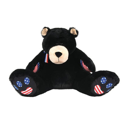 Meet Bubba Bearsevelt, a 16-inch plush soft toy by Boyds Bears, featuring a black coat, beige snout, American flag designs on its paw pads and ears, and a red, white, and blue ribbon.