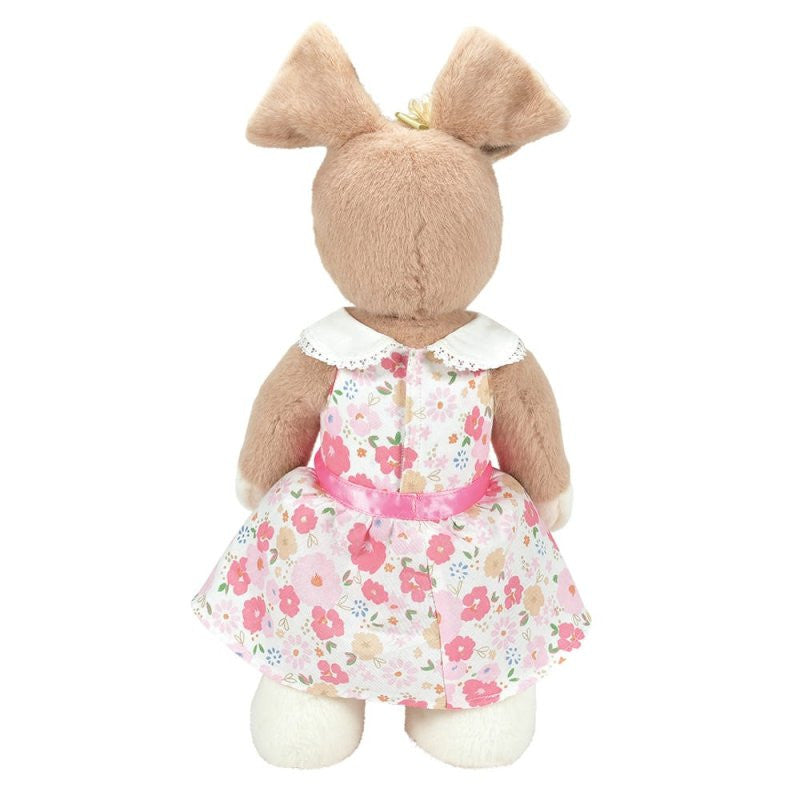 Honey Hopplebuns, a 14-inch brown plush bunny by Boyds Bears, stands facing away in a white dress with pink and red florals and a white collar. With upright ears and white feet, it celebrates Boyds Bears’ 45th anniversary collection.