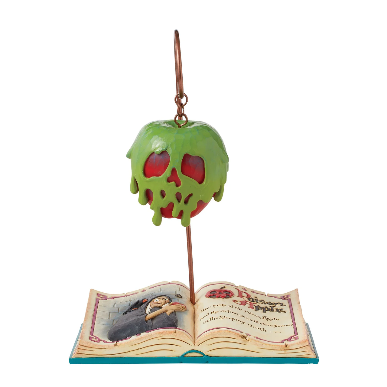 The Disney Traditions Apple-solutely Wicked (Poisoned Apple Book) by Jim Shore features a green Poisoned Apple with skull, hanging above an open book showing the Evil Queen from Snow White, in Jim Shores signature style.