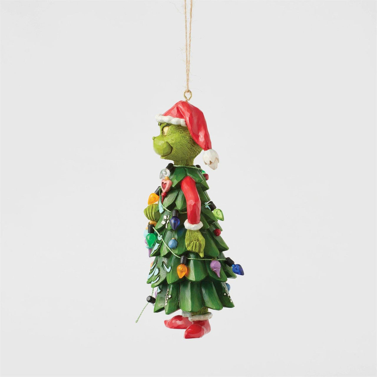 The Grinch By Jim Shore 6017078 ornament features the Grinch dressed as a Christmas tree with colorful lights and a Santa hat, hanging from a string—perfect for adding festive cheer to your holiday décor.