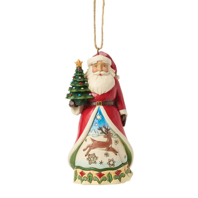 The Heartwood Creek By Jim Shore Santa With Vintage Christmas Tree Hanging Ornament (6017046) features Santa in a red coat with a tree, reindeer, and snowflake details, bringing festive charm to your décor.
