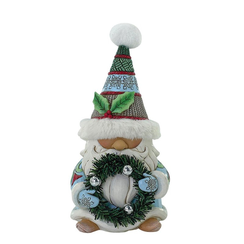 The Heartwood Creek By Jim Shore Wreathed In Holiday Joy Figurine (Gnome With Wreath & Fur Trimmed Hat) is perfect Christmas decor, featuring a festive gnome holding a wreath, from the renowned Heartwood Creek By Jim Shore collection.