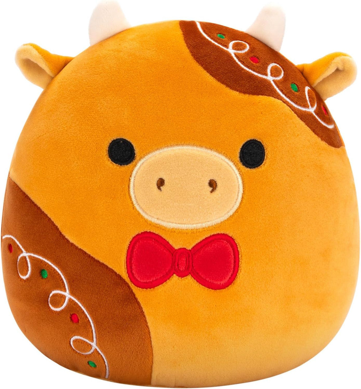 Squishmallows Jericho the Gingerbread Cow is a round, plush collectible featuring small white horns, black eyes, a beige snout, red bow tie, and gingerbread-inspired icing accents—perfect for fans of the Squishmallows brand.