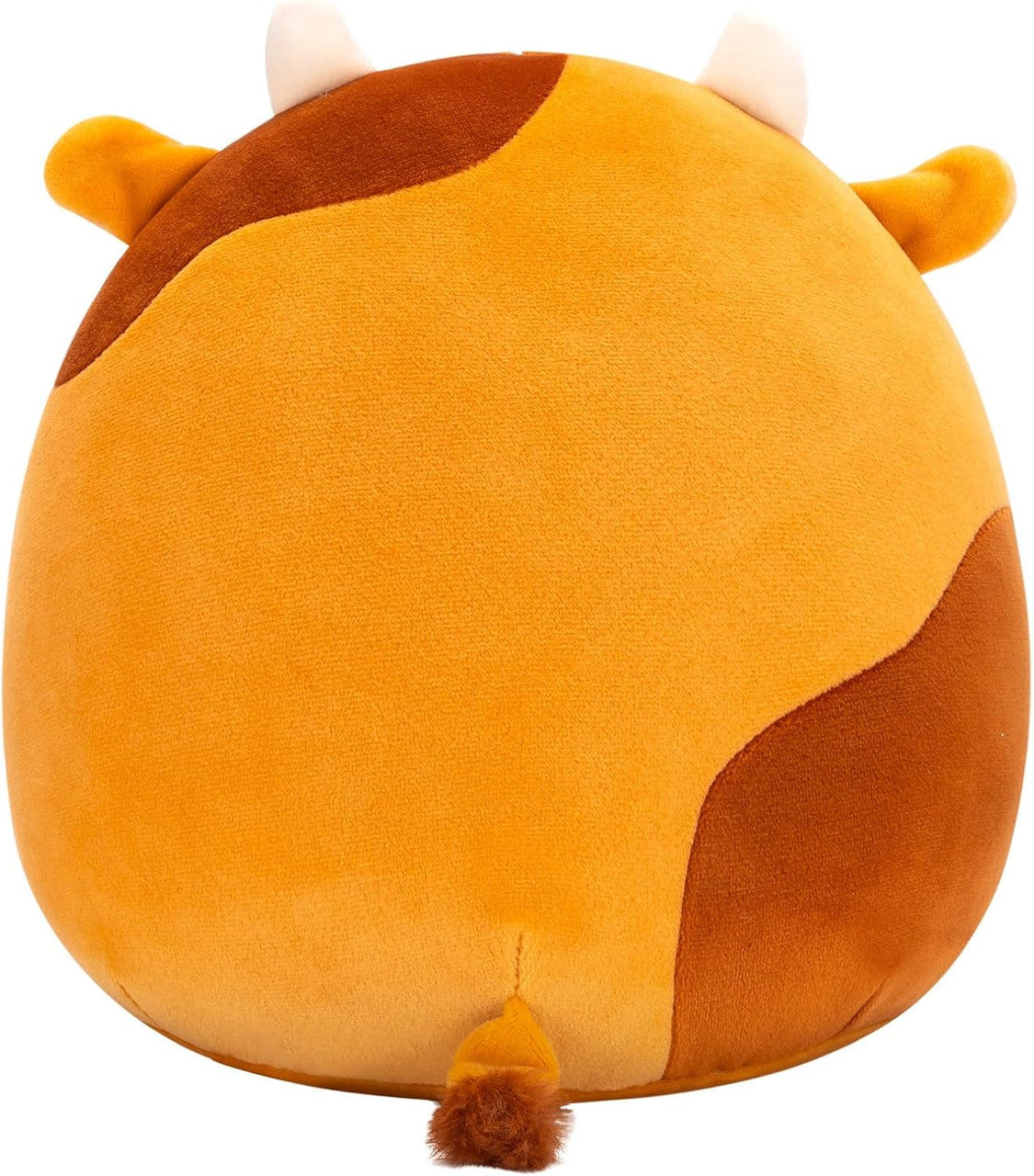 The Squishmallows Jericho the Gingerbread Cow collectible plush is mostly orange with brown patches, small white horns, orange ears, and a tiny brown tail. Seen from the back, it has a round, plush cow shape. Brand: Squishmallows.