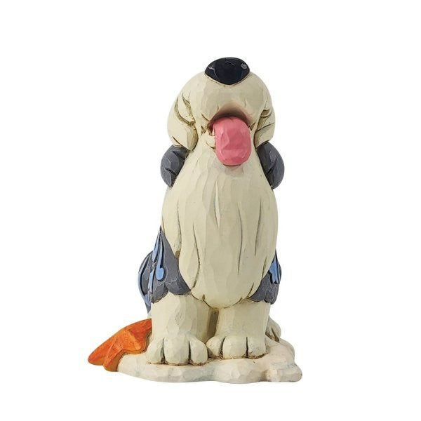 The Disney Traditions Max Mini Figurine 6014334 features a shaggy dog with long fur covering its eyes, a black nose, and tongue out, sitting on a rounded base with an orange detail near its tail.