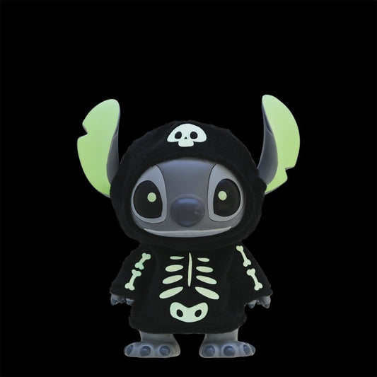The Grand Jester Studios Halloween Glow In The Dark Skeleton Stitch by Disney features Stitch in a black hooded costume with glowing green bones and a skull, perfect Halloween decor set against a plain black background.