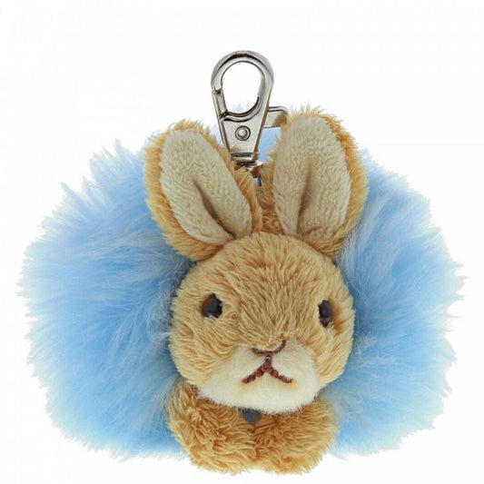 The Beatrix Potter Peter Rabbit Pom Pom Keyring Bag Clip by Beatrix Potter features a plush bunny face with tan fur, upright ears, and soft blue pom pom fur, plus a metal clip for attaching to bags or keys.