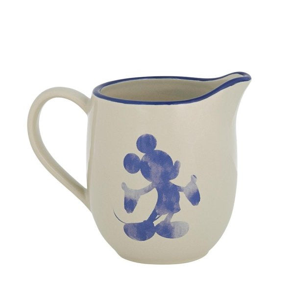 The Disney Home Mono Cream Jug A30830 is a cream-colored stoneware jug with a blue rim and handle, featuring an abstract blue cartoon mouse silhouette—ideal for any Disney fan.