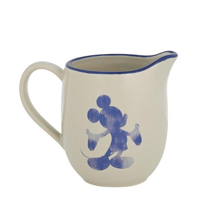 The Disney Home Mono Cream Jug A30830 is a cream-colored stoneware jug with a blue rim and handle, featuring an abstract blue cartoon mouse silhouette—ideal for any Disney fan.