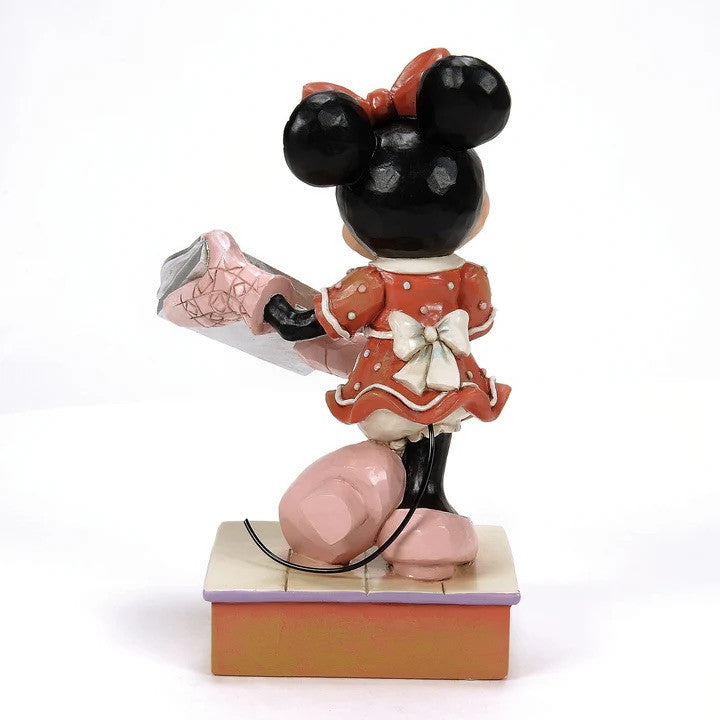 The Disney Traditions Baking Bliss (Minnie Gingerbread Cookies) Figurine By Jim Shore 6016881 features Minnie Mouse in a festive scene, available for pre-order from Disney Traditions.