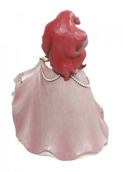 The Enesco Disney Traditions Ariel Deluxe A Precious Pearl Figurine by Jim Shore (6010100) shows Ariel with long red hair in a flowing light pink dress and pearl necklace, beautifully detailed and viewed from the back.
