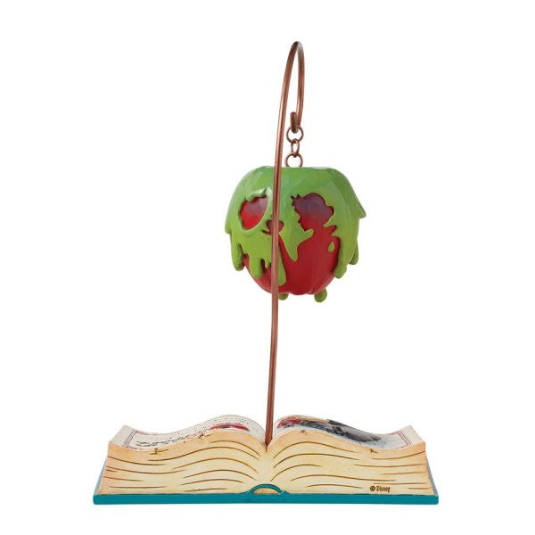 The Disney Traditions Apple-solutely Wicked (Poisoned Apple Book) By Jim Shore 6016597 is a decorative ornament featuring the iconic poisoned apple with green drips, suspended above an open book base.