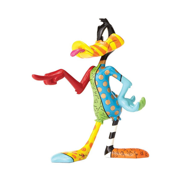 The Enesco Looney Tunes Britto Daffy Duck Figurine 4052547 features Daffy standing upright and pointing left, hand-painted with vibrant, mismatched colors and patterns on each part, set against a white background.