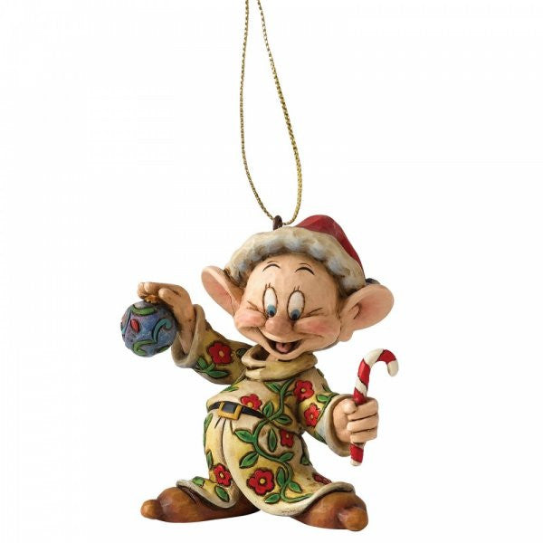 The Disney Traditions Dopey Hanging Ornament A9041 features the beloved character in festive attire with a blue ornament and candy cane, hanging from a gold string—a perfect collectible for Disney Traditions fans.