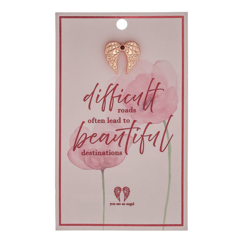 The You Are An Angel Difficult Roads Pin Card (ANCP077) features an elegant gold angel pin on a gift card with pink watercolor flowers and the message, “difficult roads often lead to beautiful destinations. You are an angel.”.