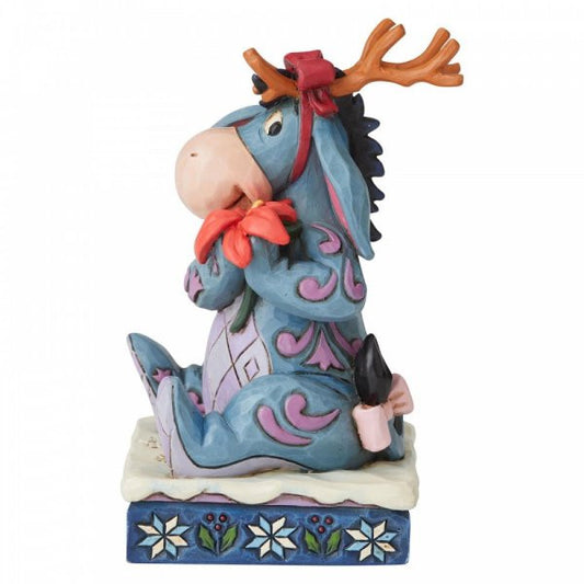 Disney Traditions Eeyore from Winnie the Pooh wears antlers and carries a poinsettia figurine