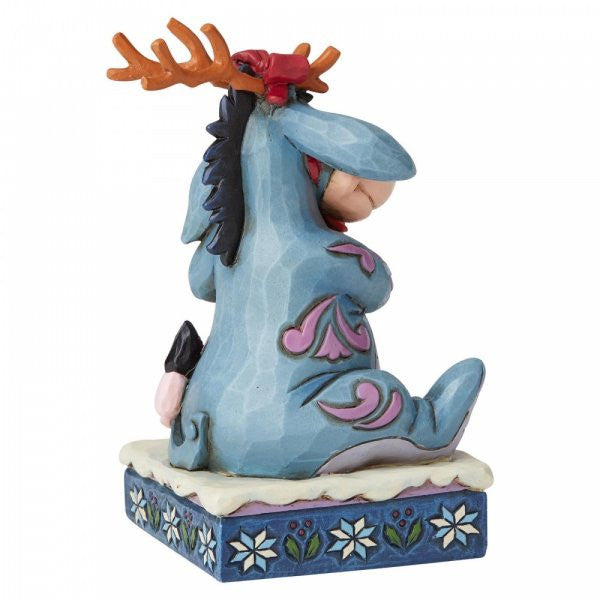 Disney Traditions Eeyore from Winnie the Pooh wears antlers and carries a poinsettia figurine