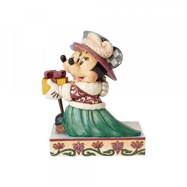 Disney Traditions Mickey and Minnie dressed in Victorian holiday outfits, Minnie holds a present Figurine