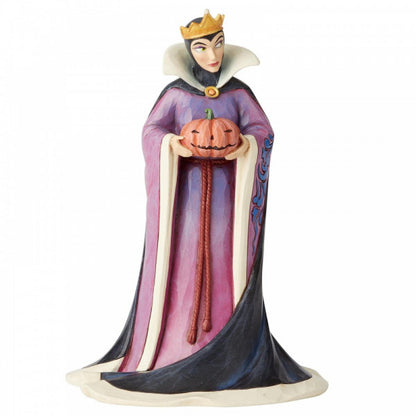 Disney Traditions Evil Queen from Snow White holds a pumpkin figurine