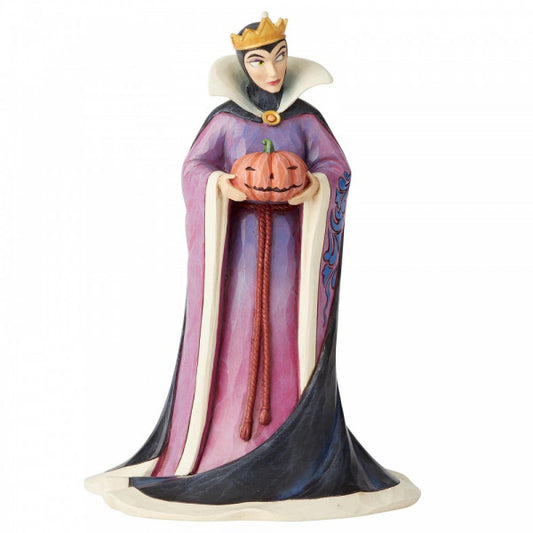 Disney Traditions Evil Queen from Snow White holds a pumpkin figurine