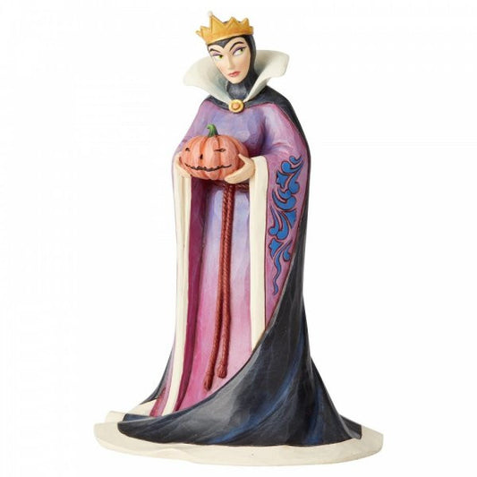 Disney Traditions Evil Queen from Snow White holds a pumpkin figurine