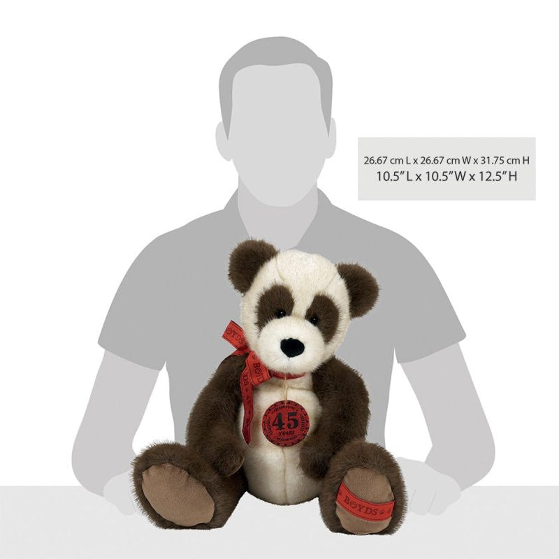 A brown and white Anni Bearsley Jointed Bear 16 Inch Plush Soft Toy by Boyds Bears features a red ribbon and 45 Years badge, posed before a gray silhouette to show its size. From the anniversary collection. Dimensions: 10.5”L x 10.5”W x 12.5”H.