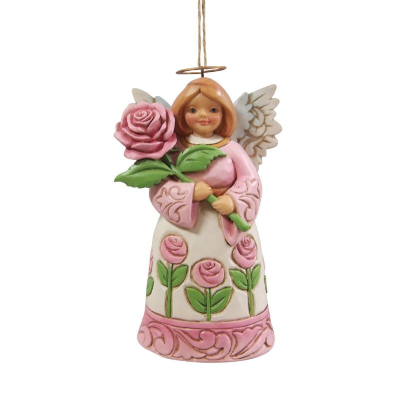 The Heartwood Creek By Jim Shore Angel With Roses Hanging Ornament (6017304) features an angel with wings, light brown hair, a gold halo, white dress with pink roses, holding a rose and includes signature Heartwood Creek details and hanging string.