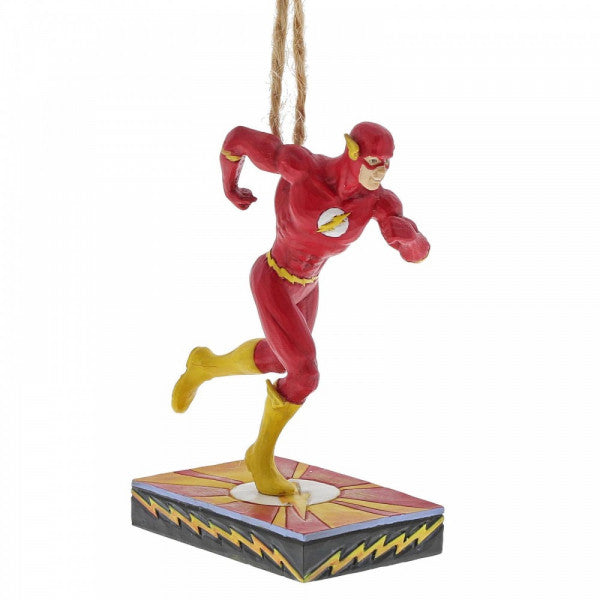 The DC The Flash Silver Age Hanging Ornament by Jim Shore features The Flash in his red suit with yellow boots and lightning bolt symbol, posed as if running—perfect for any Justice League fan. From DC Comics By Jim Shore.