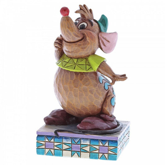 Disney Traditions Gus, the mouse friend of Cinderella,  eagerly anticipating a yummy snack, his round belly protruding beneath a snug green tee figurine